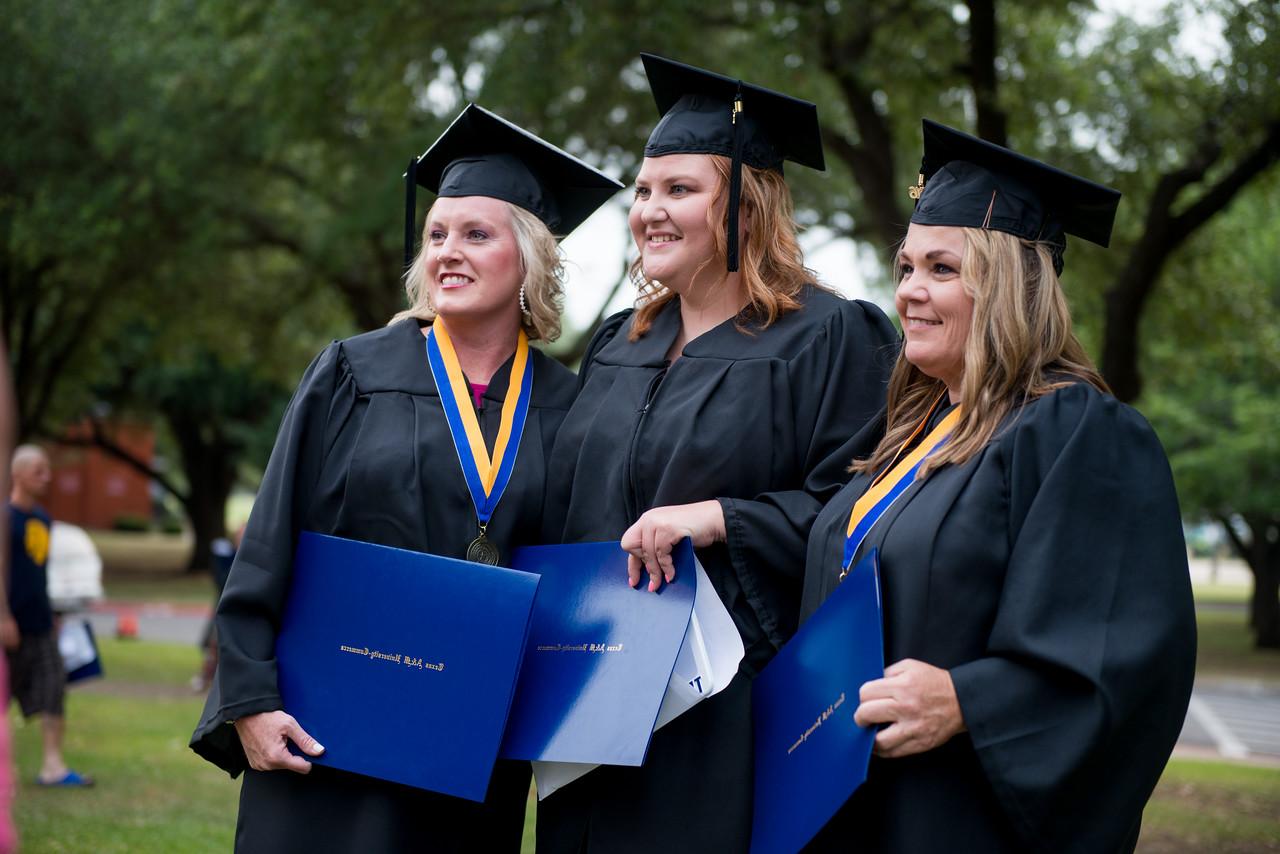 three female graduates talking a pitcure with their diplomas.